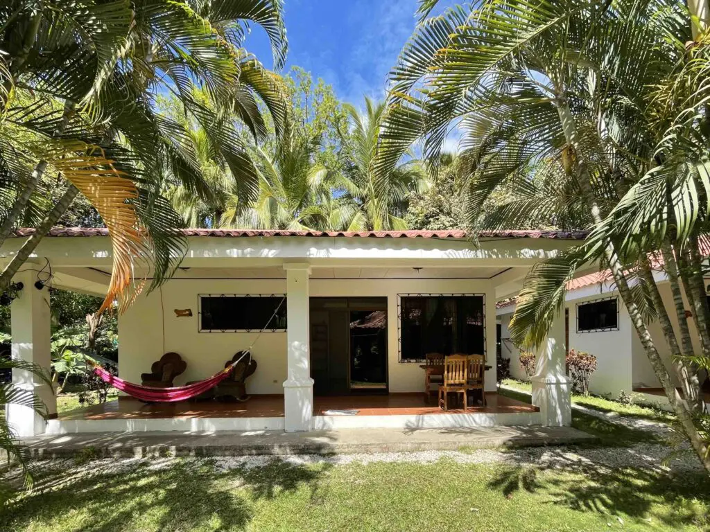 A Bungalow With a Green Lawn With a Veranda